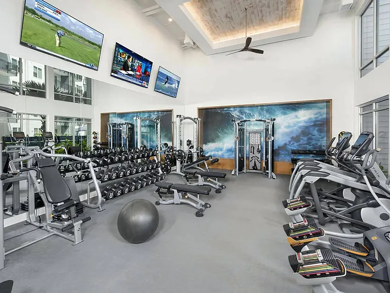 Fitness Center with Free Weights, Cardio Machines, and Mounted TVs