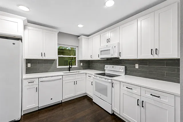 Bright modern kitchen featuring quartz countertops, contemporary finishes, and an open-concept layout.