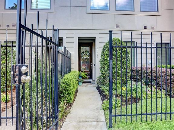 The gated front yard contains the nicely landscaped gardens that line the front of the home.