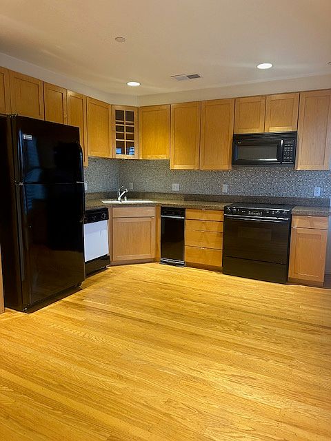Kitchen offers Dishwasher, Disposal with newer refrigerator and microwave over electric stove.