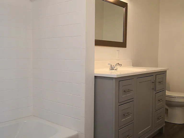 Full bathroom with new vanity, tub, tiles, flooring, lightin