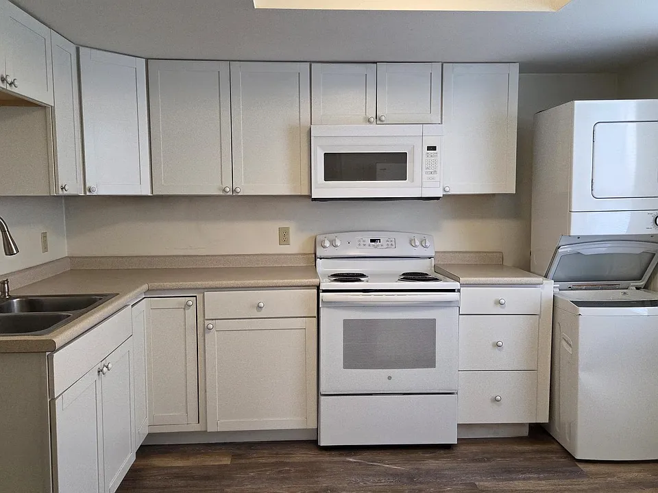Kitchen with Stackable Washer & Dryer, Microwave, Stove and Refrigerator