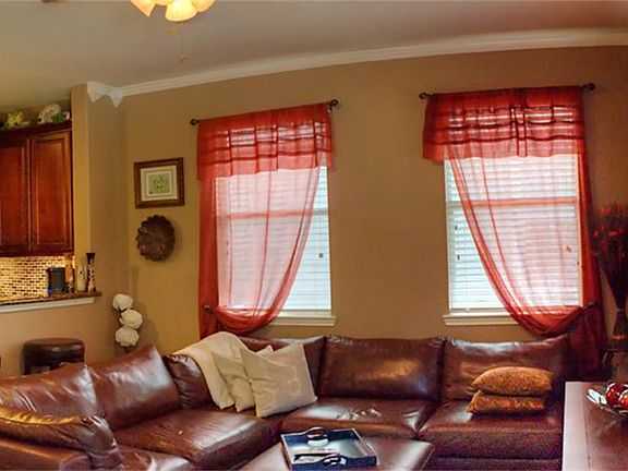 Living room with fresh paint, crown molding, and wood floors!