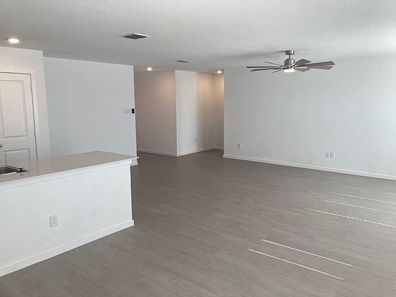 Family Room Taken From Dining Room. Kitchen Is On The Left. Openings To The Foyer And Primary Bedroom Are In The Right Background.
