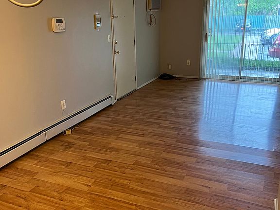another view of dining room and living room, the entrance door