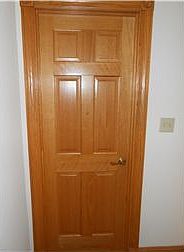 Solid six-panel wood doors throughout