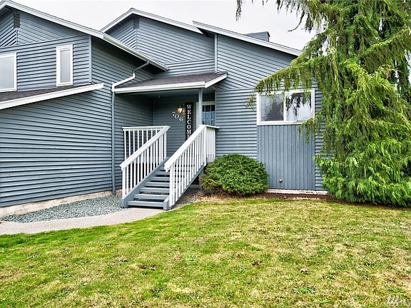 Front steps to covered porch, freshly painted railings and steps.