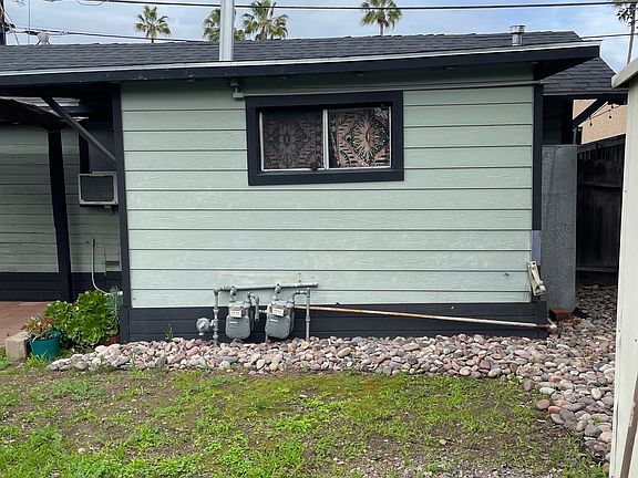 Portion of rear private fenced yard. & Kitchen window