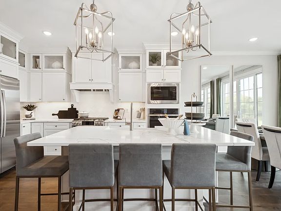 Kitchen with pendant lighting and glass upper cabinetry