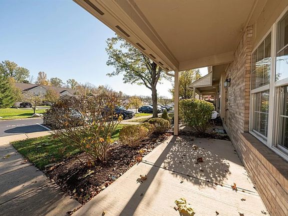 Covered front porch and assigned parking space in front of townhouse