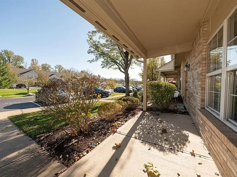 Covered front porch and assigned parking space in front of townhouse