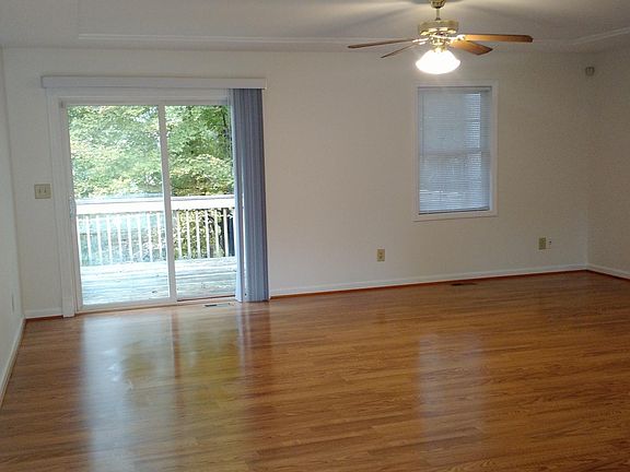 View of Greatroom as you enter the front door, looking out on to the deck on back, and out thru the trees behind the home