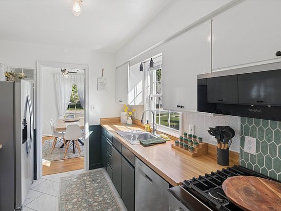 Ready to cook, bake, and gather_our South Bend kitchen features a sleek dishwasher, stainless range, stocked spices, utensils, and a pizza peel for alfresco meals near Notre Dame.