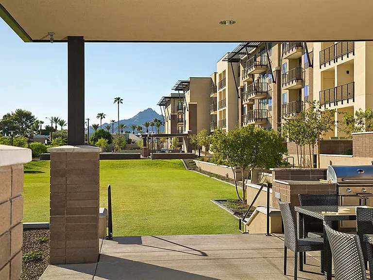 Community park with BBQ grills, seating and outdoor ping pong table