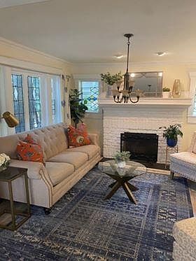 Beautiful living room filled with sunlight including the original stained glass windows