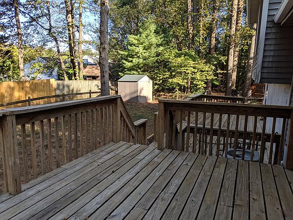 Exterior rear; deck; fenced yard; treed yard