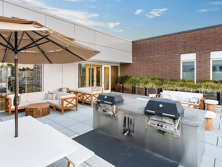 A rooftop grilling terrace at Modera Belmont, offering relaxed gathering space just steps from Belmont's local dining, shops, and everyday favorites.