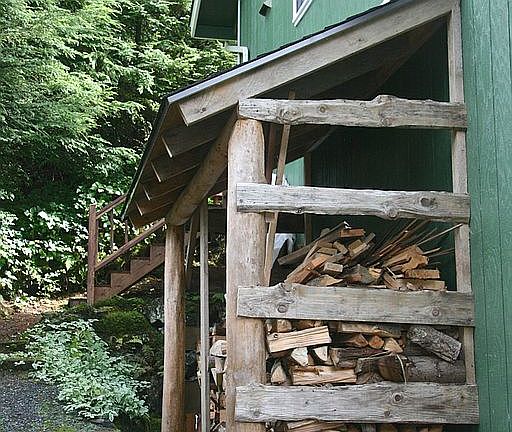 Log framed wood shed