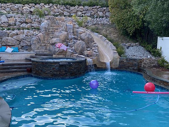North Side of backyard with pol, slide and waterfall