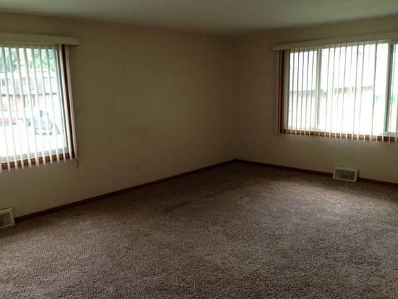 Main living area with wall to wall carpet and Central air