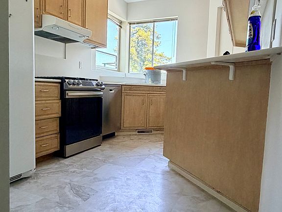 Kitchen with trash compacter, fridge freezer, oven and dish washer