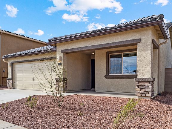 Angled exterior of the Bisbee plan, showcasing the stucco and brick finishes.