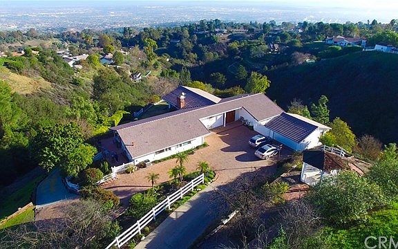Long private driveway with plenty of space to turn around and parking for many cars in addition to the two car garage.