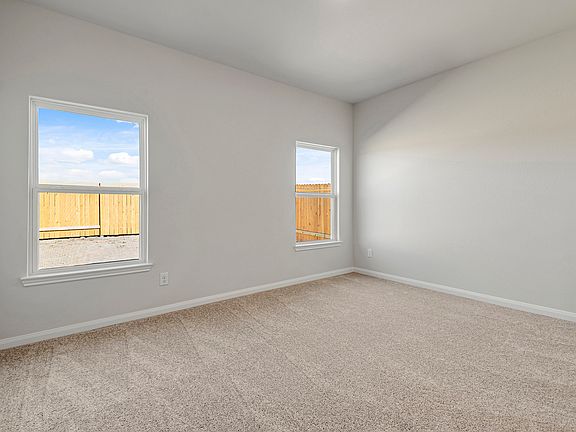 Windows let in plenty of natural light to this master bedroom.