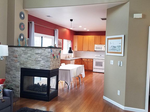 Living room and kitchen with gas fireplace.
