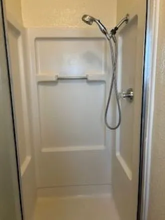 Master bath shower with hand-held nozzle