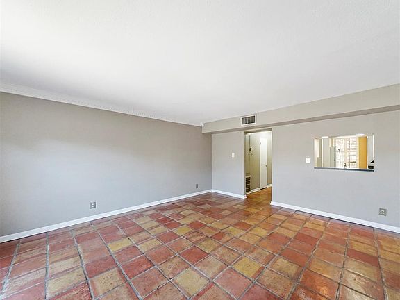 Beautiful Saltillo tiles cover the living room floor.