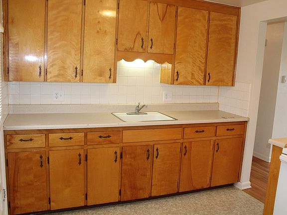 Large kitchen with lots of cabinets and all appliances.