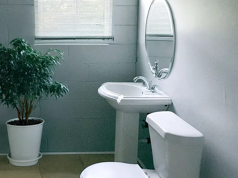 Basement bathroom with shower and washer/dryer hookups. Furnishings and decorations not included.