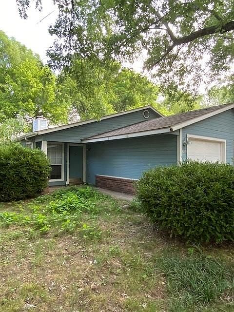 Exterior view-one car garage. Property has a fenced side yard and backyard with lots of trees
