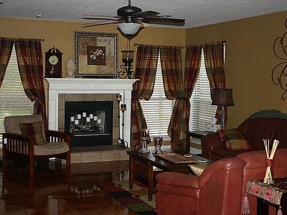  A very large living area with a nice mantel and windows overlooking the large backyard.