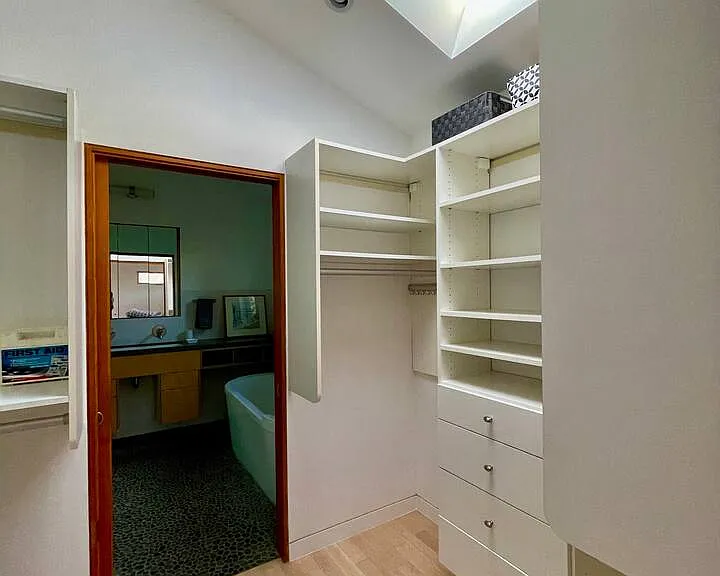 Master bedroom walkin closet - two sides, skylight, built in closeting/storage