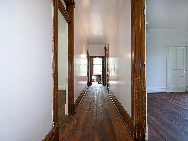 hallway, room B to right room C to left, doors to bath and kitchen at end of hall to left and right, door to back stair hall at end of hall straight ahead