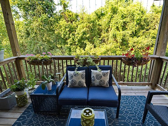 Enjoy time outside on my cozy covered deck that overlooks the back greenspace