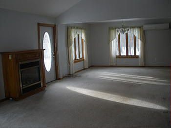 large living and dining room, open concept to kitchen with beautiful view of wooded back yard