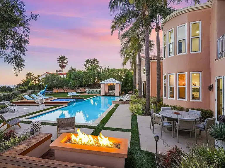 By night, set the mood with the outdoor fire pit and twinkling sky.