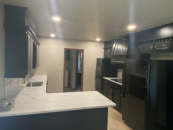 Kitchen with access to laundry, half bath, and garage.