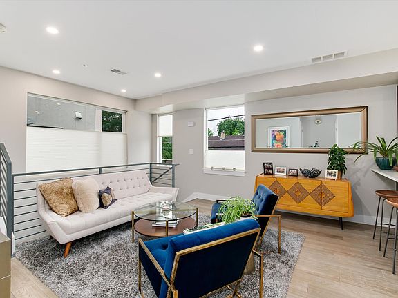 Main floor seating area with bar; can also be used as dining room. High ceilings and lots of natural light.