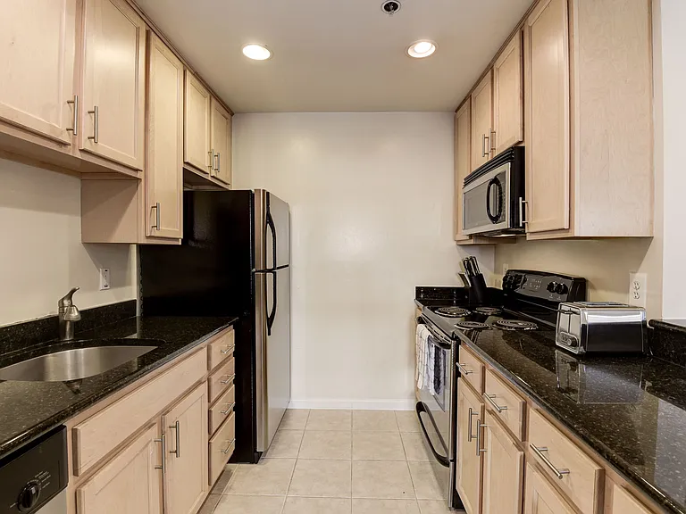 Gourmet Kitchen with Dishwasher, Garbage Disposal, Microwave, Granite Countertops, and Modern Appliances