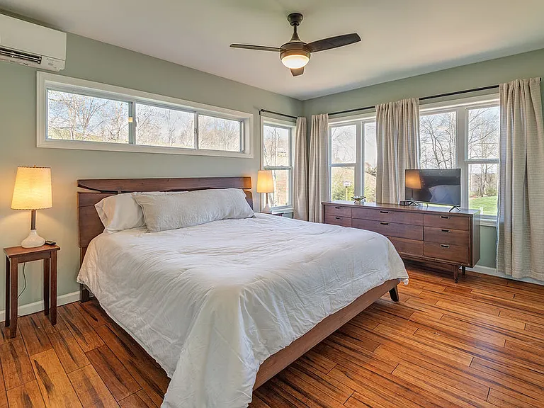 The primary bedroom offers natural light and beautiful hardwood floors