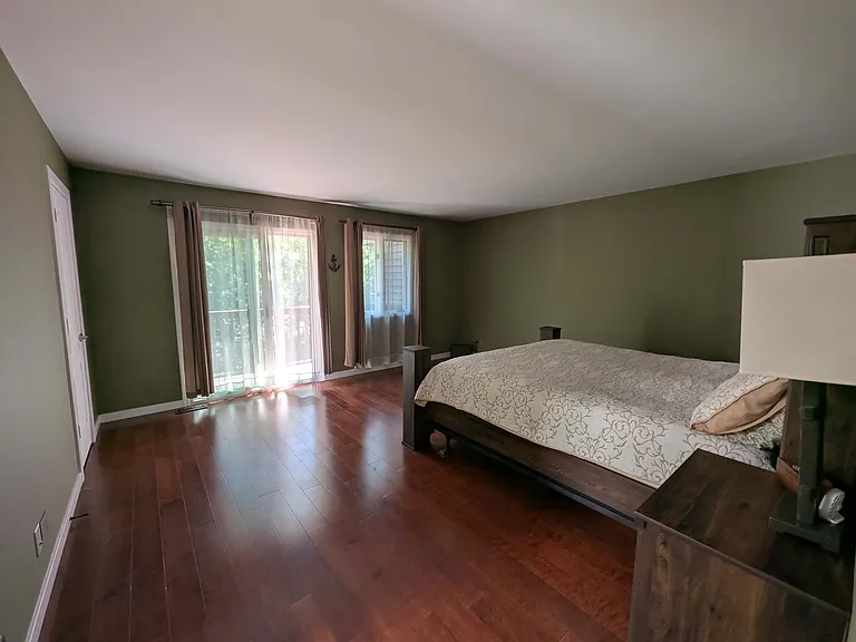 Hardwood floors throughout second floor without a single transition give the master bedroom cozy and warm feeling
