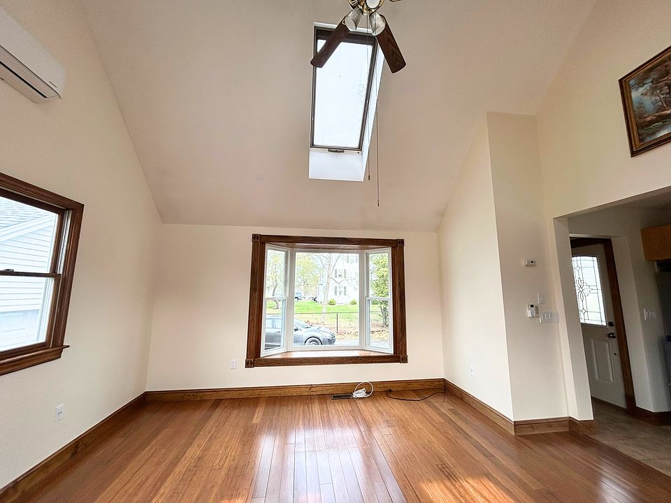 Living/Dining area with access to private back deck, ceiling fan with lights on dimmers, skylights
