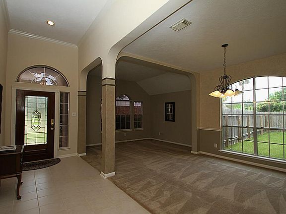 Amazing foyer entry way with crown molding and arches into the formal living and dining space.