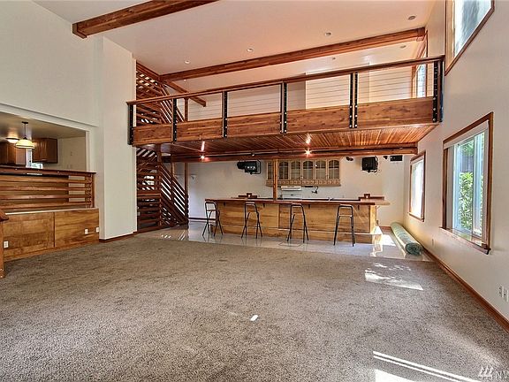Another angle of the great room looking towards the 2nd kitchen/bar and loft.  Notice the beautiful open wire loft railing and t