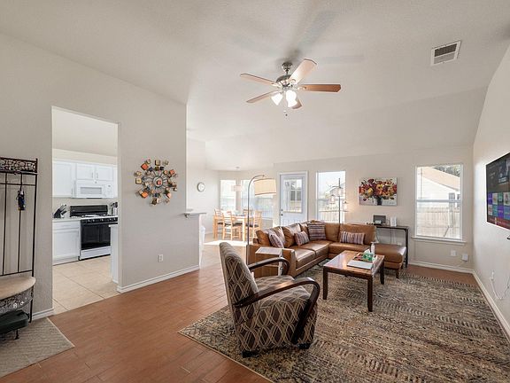 Open concept living, dining, and kitchen area with 10 ft ceilings.