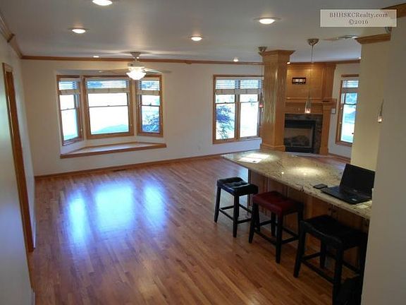 Spacious dining and entertainment space with beautifully refinished hardwoods and granite. Look at a